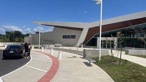 Front of New Train station building with a car pulled-up in the drop off area
